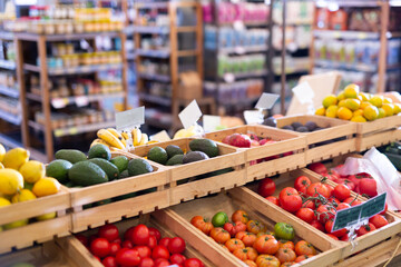 Fresh vegetables and fruits on counter in a grocery supermarket