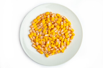 Yellow capsules on a white plate