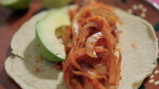 Vegan Mexican tinga taco on traditional clay plate