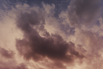 Dark clouds in the burgundy sky.
