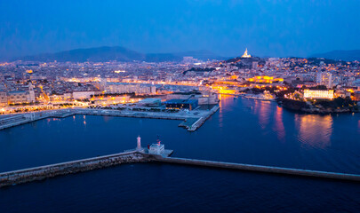 Bir's eye view of Marseille in evening with turned on city lights. Palais du Pharo visible from above.