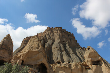 high sand-colored rocks with the remains of ancient settlements inside