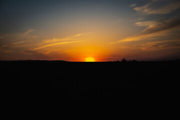 Orange sunset over a dark sky.