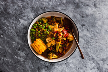 vegan mixed vegetable roast with spicy broth, healthy plant-based food