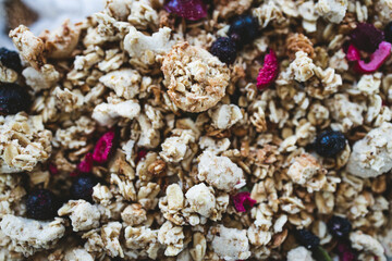 vegan homemade granola with oats grains and dried fruits in glass lunch box, healthy plant-based food