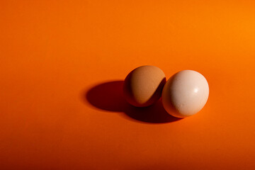 whole eggs on healthy orange background