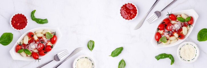 Gnocchi with tomatoes, red sauce, cheese and basil leaves