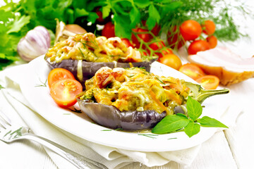 Eggplant stuffed smoked brisket and vegetables in plate on light board