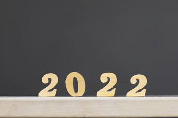 2022 wood number on grey background for new year concept