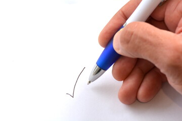 Pen hand ticks white paper
