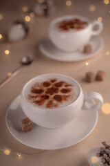 a cup of cappuccino with cinnamon on a festive New Year's table with lights