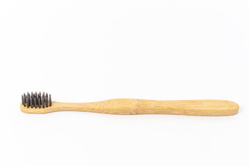 Bamboo toothbrush on white background with copy space.