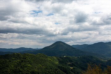 Naklejka na ściany i meble View to mountain and forest with cloudy sky