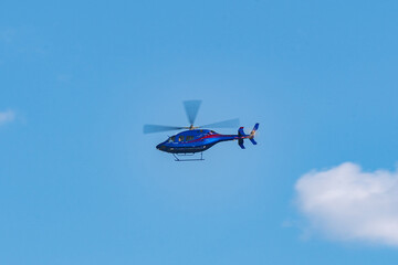 Helicopter flying in the sky during a sunny day