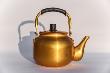 Chinese Teapot on white background. The Chinese tradition, antique metal teapot isolated on white background, antique kettle, golden teapot, metal teapot.