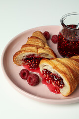 Concept of delicious food with croissant with raspberry jam on white background