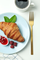 Concept of delicious food with croissant with raspberry jam on white background