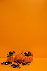Orange Halloween background with pumpkins and spiders