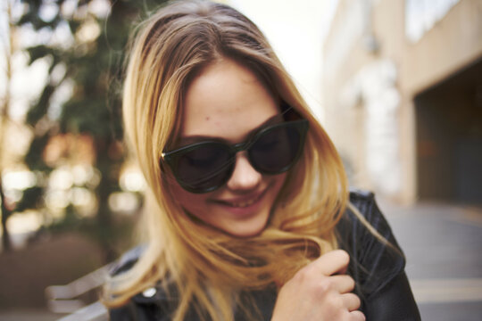 woman wearing sunglasses outdoors near building walk fashion glamor