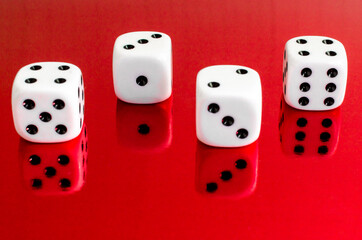 Group of white dice reflected in red background