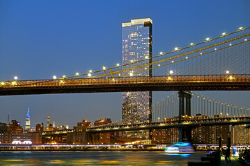 Brooklyn Bridge and Manhattan Bridge in evening, suspension bridges that crosses East River in New...