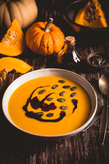 Homemade pumpkin soup with pumpkin oil and seeds