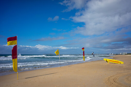 Lifeguard Surfboard and warning Flags on beach, Mudjimba Beach, Queensland, Australia