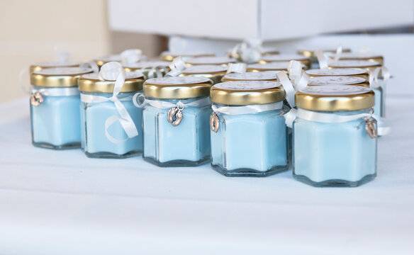 Blue candles in glass jars for a baptism ceremony