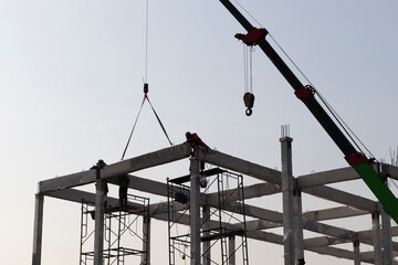 precast concrete beam intralled at construction site by mobile crane