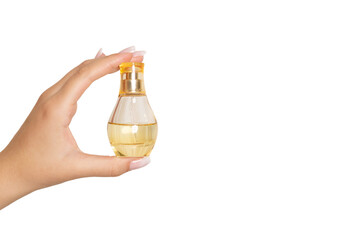 female hand holding bottle with perfume water