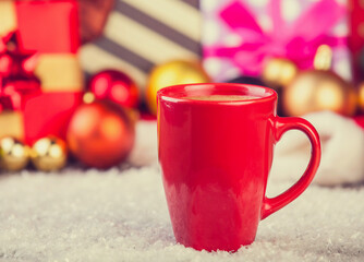 Cup of coffee and gifts at background