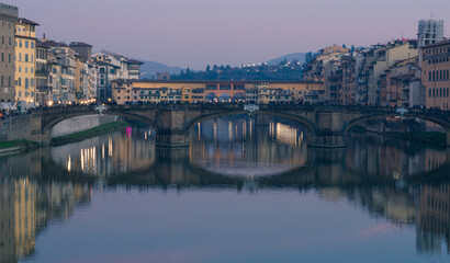 Fototapeta na wymiar Evening view of the Arno River with reflections