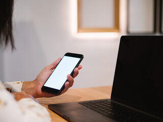 unrecognizable working woman's hand holding a phone while viewing it