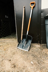 Pitchfork and shovel near the door. Accessories for working in the stable.