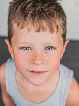 Adorable Elementary Blonde Haired Blue Eyed Boy Looking At Camera