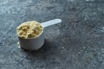 Protein powder, a full scoop of whey protein powder, sport nutrition for athletes and bodybuilders