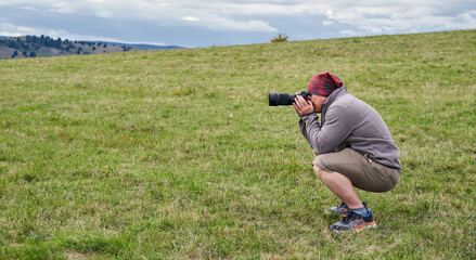 Professional nature photographer in a field