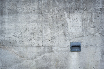 Detail of concrete cement wall texture with dark light fixture vent of metal