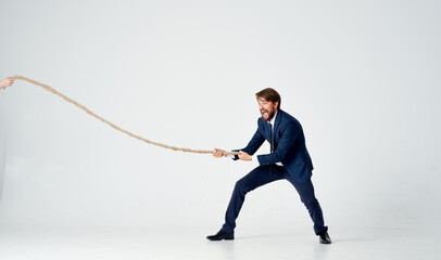 a man in a suit pulls the rope emotion work office