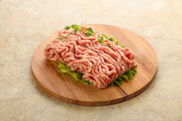 Raw minced pork meat over board