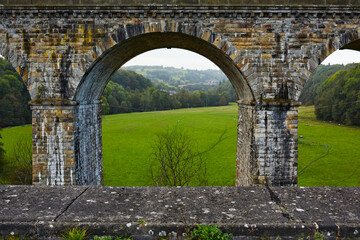 Fields viewed through viaduct arch, taken from aqueduct in Chirk, North Wales
