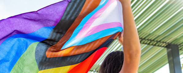 Progress pride flag. Lesbian Girl Holding LGBT Flag. - obrazy, fototapety, plakaty