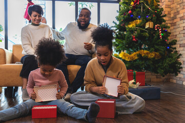 African American family unpacking Christmas gift