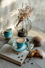 beautiful vintage cup of coffee with milk and gingerbread on the table