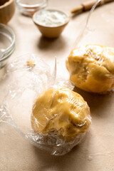 Raw dough wrapped in plasti foil, ready to be cooled in the fridge, cooking a pie, tart or cookies. Step by step recipe.