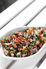 traditional greek Ktapodi octopus salad bowl on Athens restaurant table