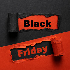 Torn paper with Black Friday text. Closeup