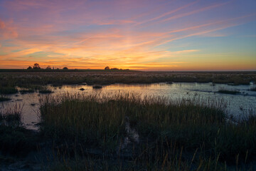 scenic sunset over water of Langwarder Groden (Butjadingen, Germany)