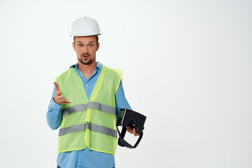 engineer in a white helmet construction VR glasses isolated background