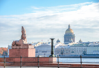 View of the Egyptian Sphinx Statue on the University Embankment and the dome of St. Isaac's Cathedral in St. Petersburg, Russia